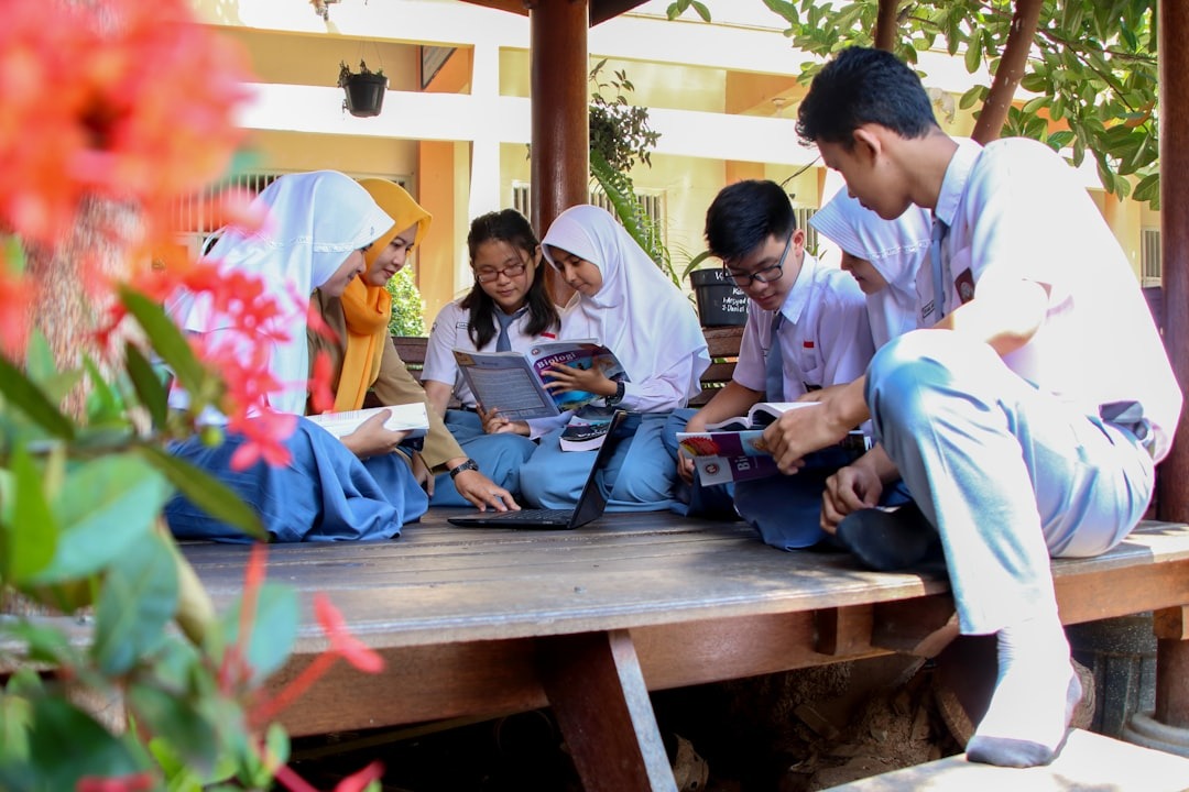 Students collaborating on schoolwork at an outdoor pavilion.